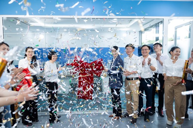 Balas Technologies team celebrating the grand opening together with confetti.